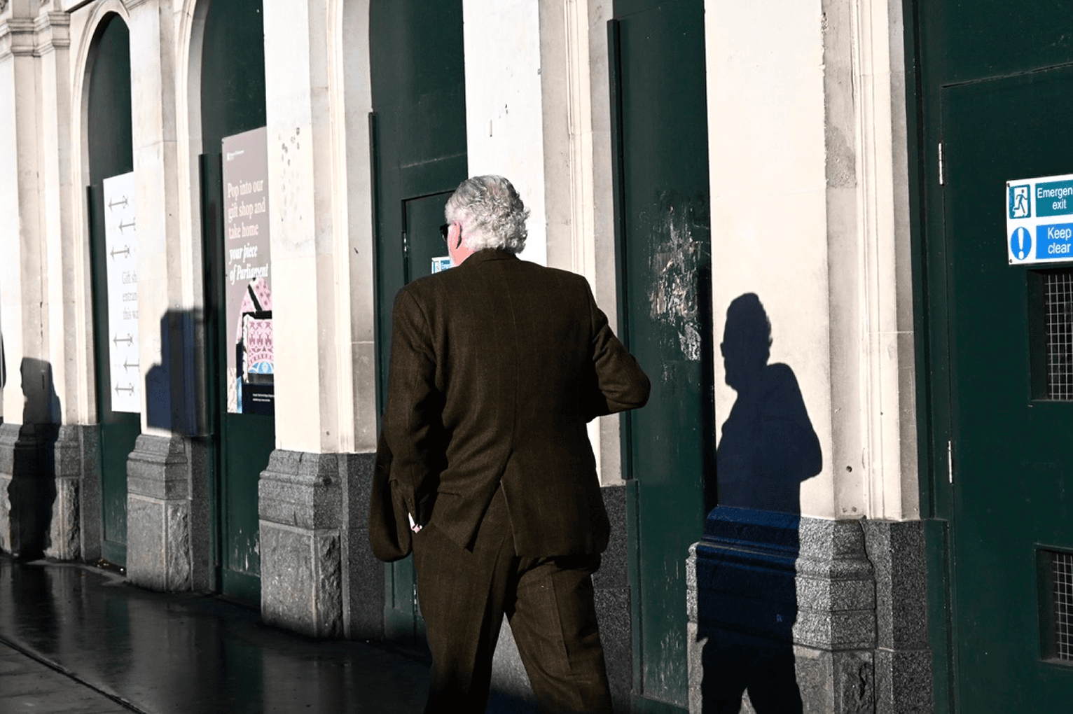 Person casting a long shadow on a wall