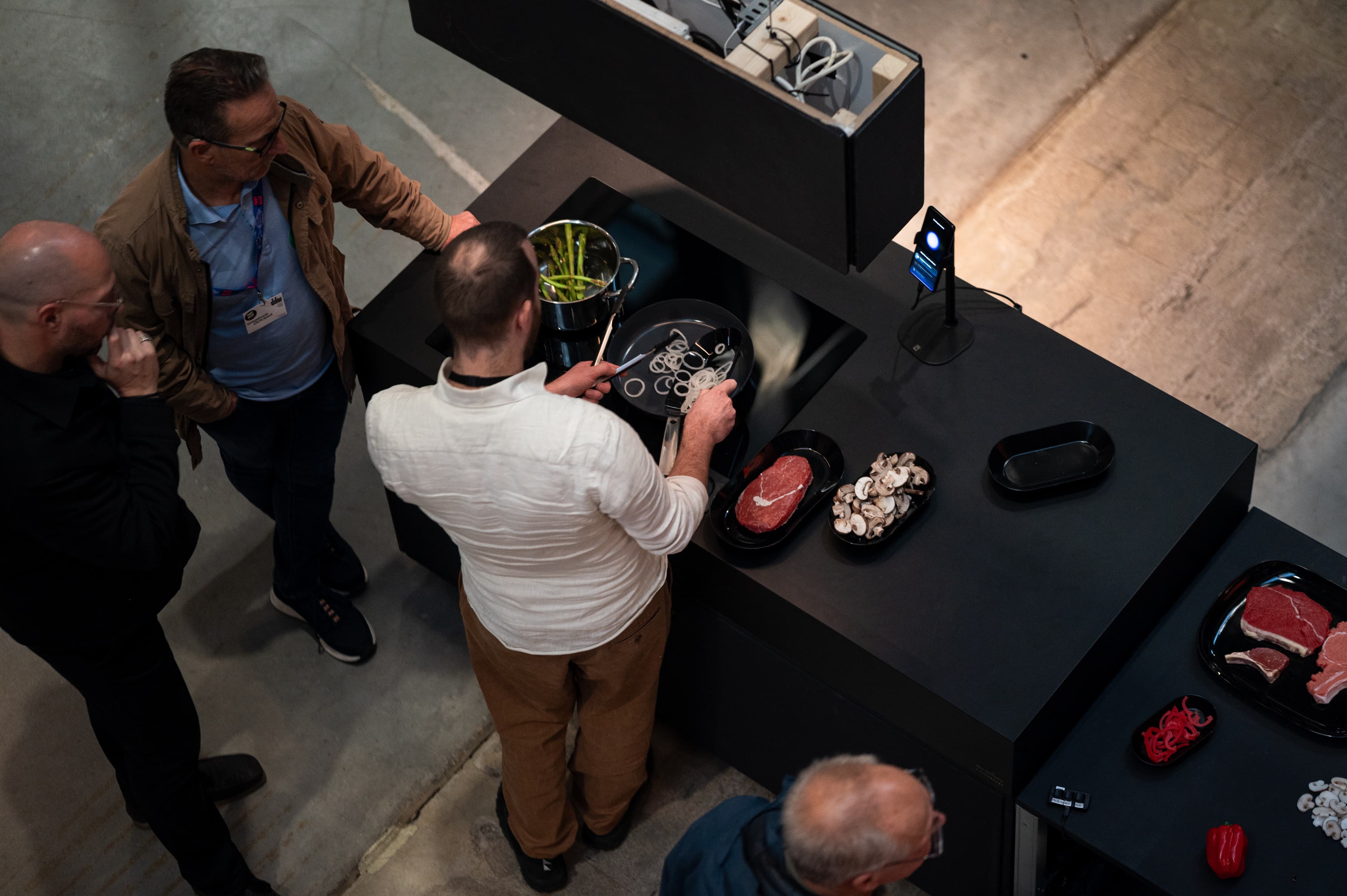 Close-up of a hand cooking on the AI kitchen hob