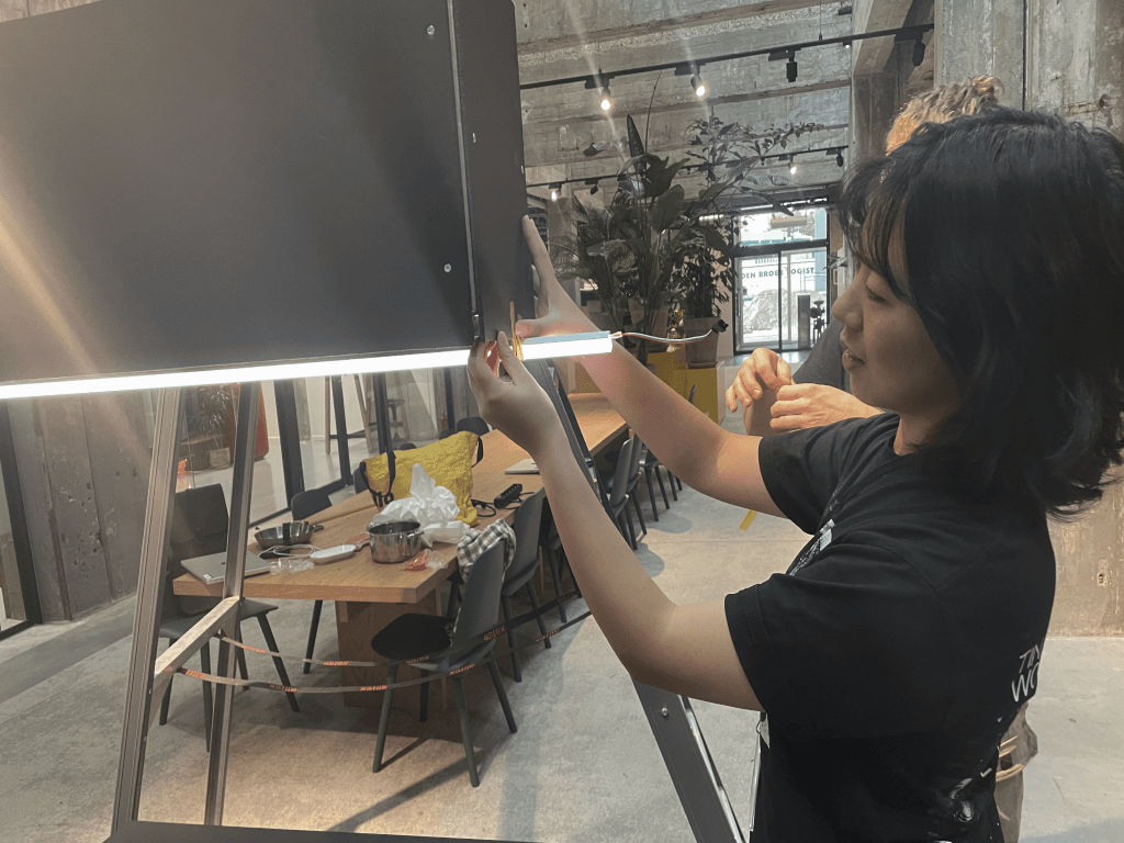 Hands assembling lighting on the kitchen hood prototype