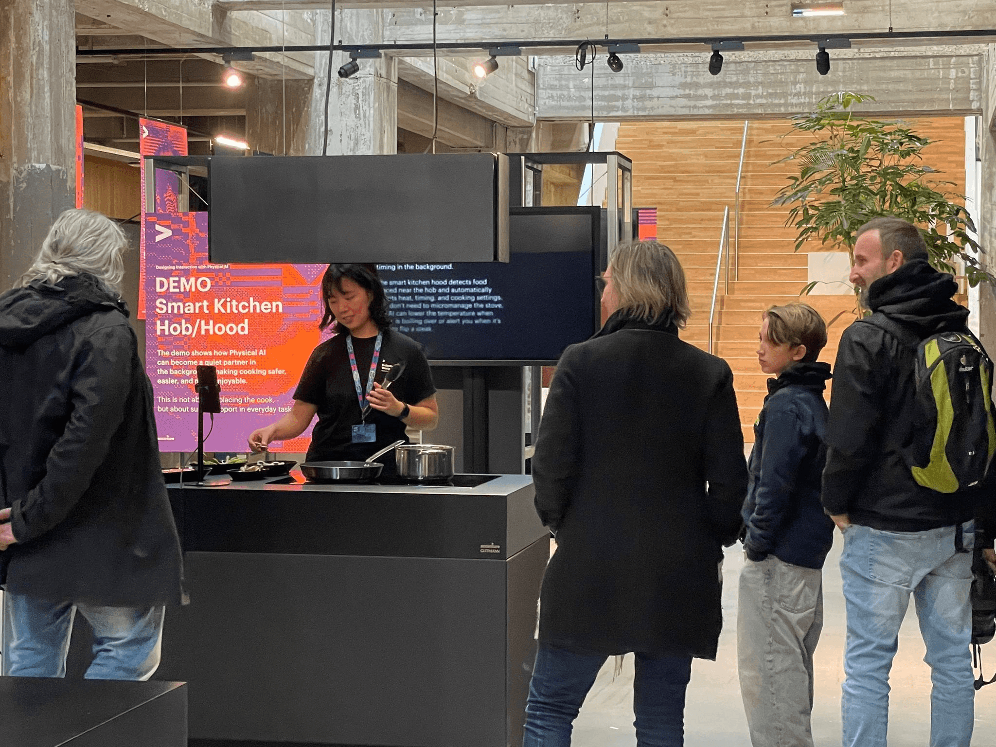 Presenter at the Smart Kitchen Hob demo booth during Dutch Design Week